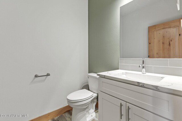 bathroom featuring vanity, toilet, and hardwood / wood-style flooring