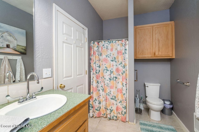 bathroom featuring tile patterned floors, vanity, and toilet