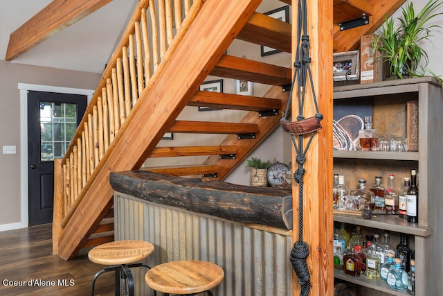 interior space with bar and hardwood / wood-style floors