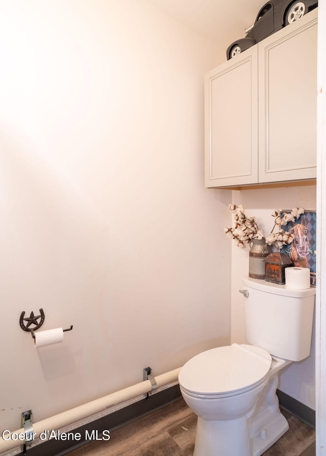 bathroom with toilet and hardwood / wood-style flooring