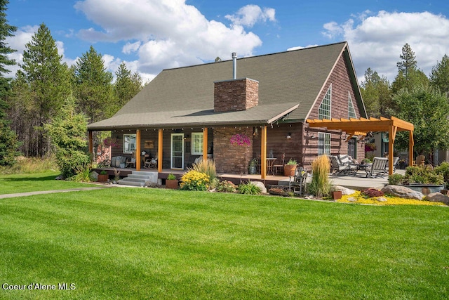 rear view of house with a lawn and a patio