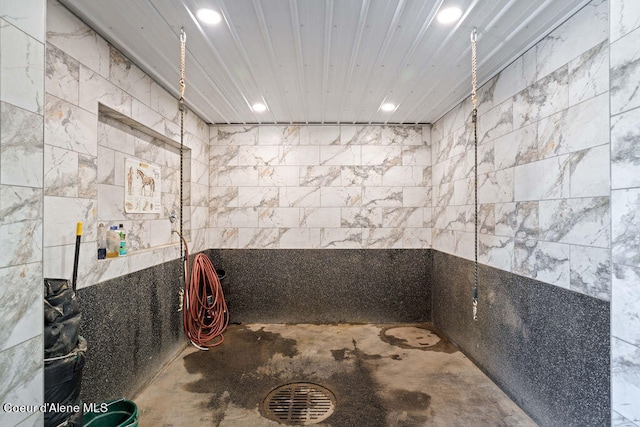 bathroom with tile walls