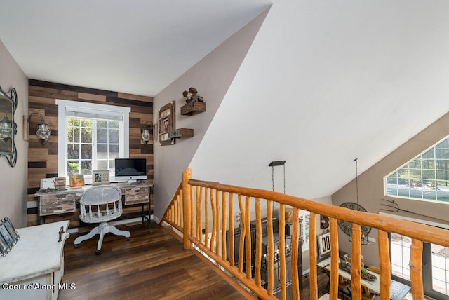 home office featuring wood walls, vaulted ceiling, and dark hardwood / wood-style floors