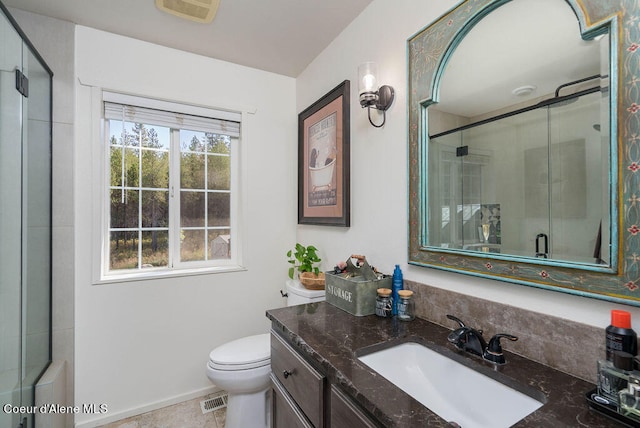 bathroom with vanity, toilet, tile patterned floors, and an enclosed shower