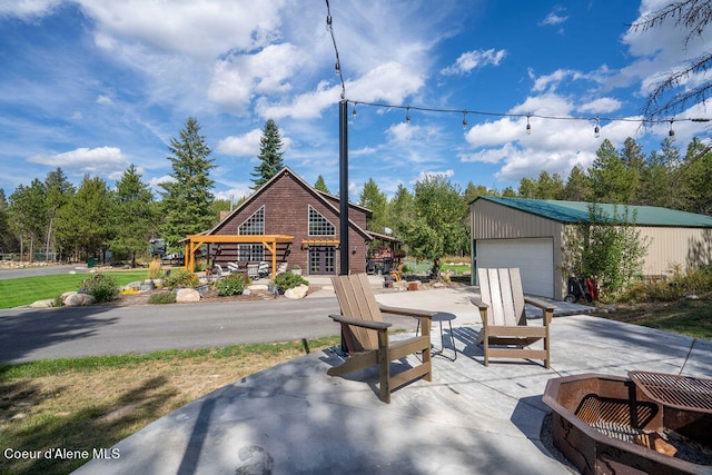 view of patio / terrace featuring an outdoor structure and a garage