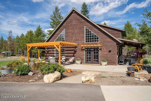 view of front facade featuring french doors and a patio area