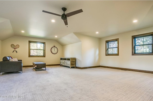 unfurnished room featuring ceiling fan, light colored carpet, and lofted ceiling