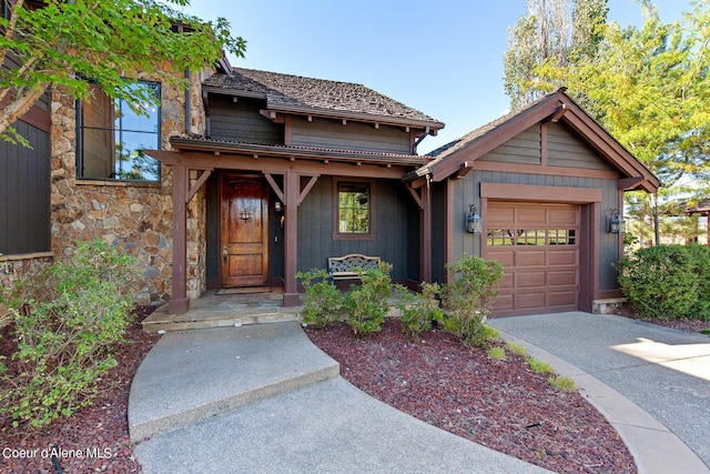 17023 S Citrine Dr, Coeur Dalene, ID 83814 - view of front of house featuring driveway, stone siding, and an attached garage