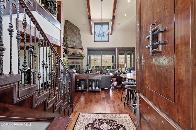 17023 S Citrine Dr, Coeur Dalene, ID 83814 - entrance foyer featuring stairway, a chandelier, wood finished floors, a stone fireplace, and a towering ceiling