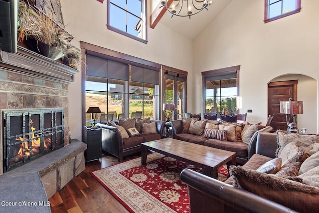 17023 S Citrine Dr, Coeur Dalene, ID 83814 - living area with dark wood-style flooring, a chandelier, a fireplace, arched walkways, and vaulted ceiling