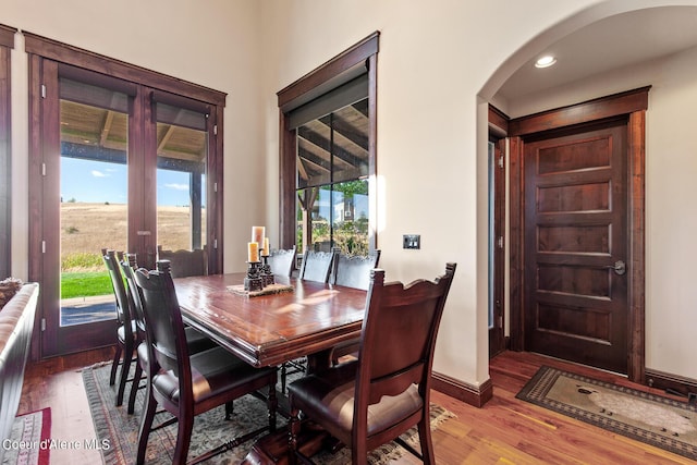 17023 S Citrine Dr, Coeur Dalene, ID 83814 - dining area featuring baseboards, wood finished floors, arched walkways, and french doors