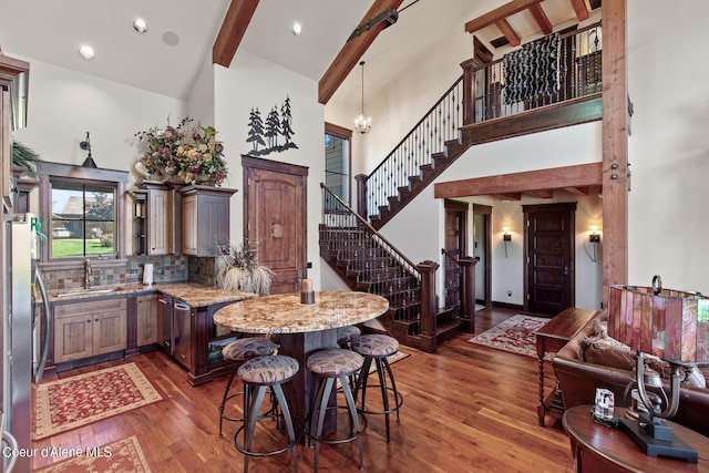 17023 S Citrine Dr, Coeur Dalene, ID 83814 - kitchen with dark wood-style flooring, high vaulted ceiling, beam ceiling, a sink, and freestanding refrigerator