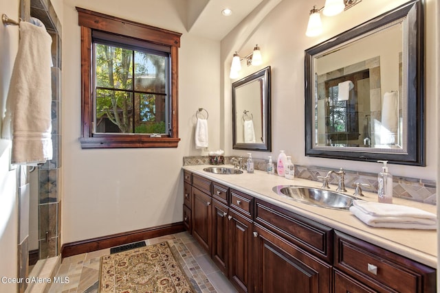17023 S Citrine Dr, Coeur Dalene, ID 83814 - full bath with baseboards, a tile shower, double vanity, and a sink