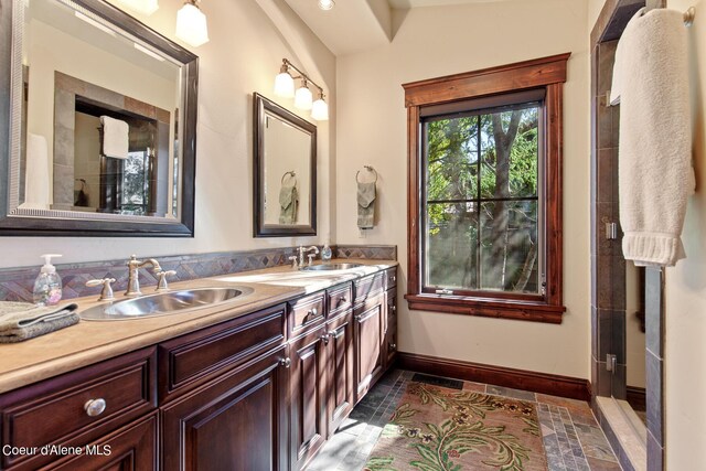 17023 S Citrine Dr, Coeur Dalene, ID 83814 - bathroom featuring baseboards, double vanity, and a sink