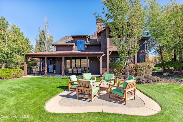 17023 S Citrine Dr, Coeur Dalene, ID 83814 - back of house featuring a balcony, a chimney, a fire pit, a yard, and a patio area