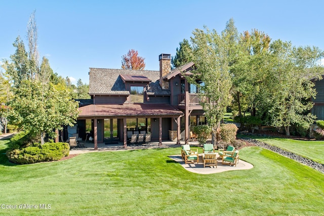 17023 S Citrine Dr, Coeur Dalene, ID 83814 - back of house with a balcony, a chimney, a patio area, and a yard