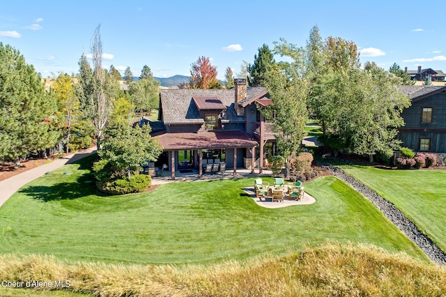 17023 S Citrine Dr, Coeur Dalene, ID 83814 - back of house featuring a patio, a chimney, and a lawn