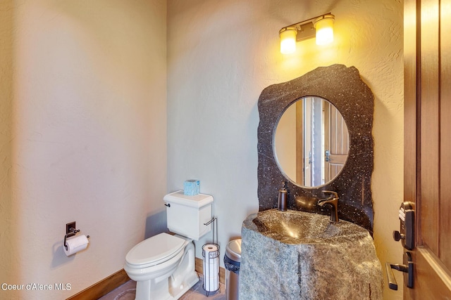 17023 S Citrine Dr, Coeur Dalene, ID 83814 - half bathroom featuring toilet, vanity, and baseboards