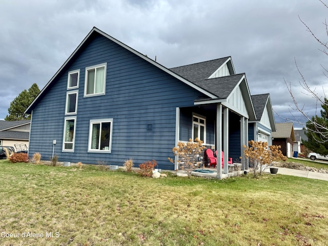 view of side of home with a garage and a lawn