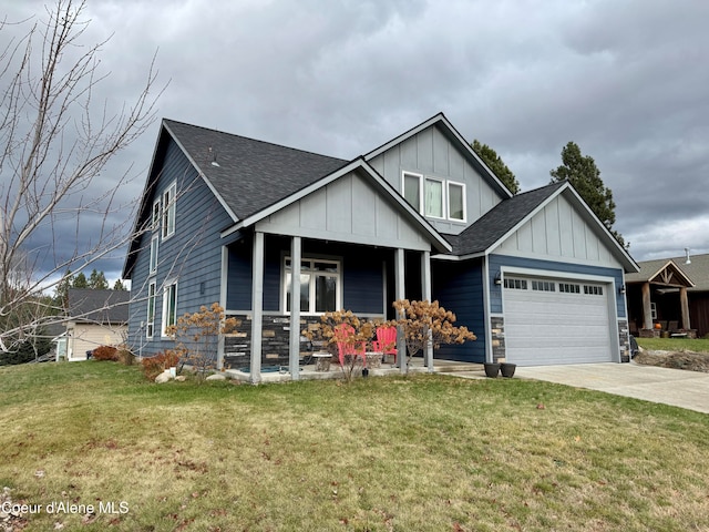 craftsman-style house featuring a garage, covered porch, and a front lawn