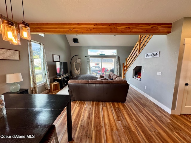 living room with lofted ceiling with beams and hardwood / wood-style flooring