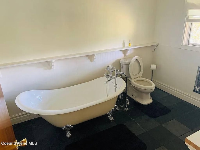 bathroom with toilet and a tub