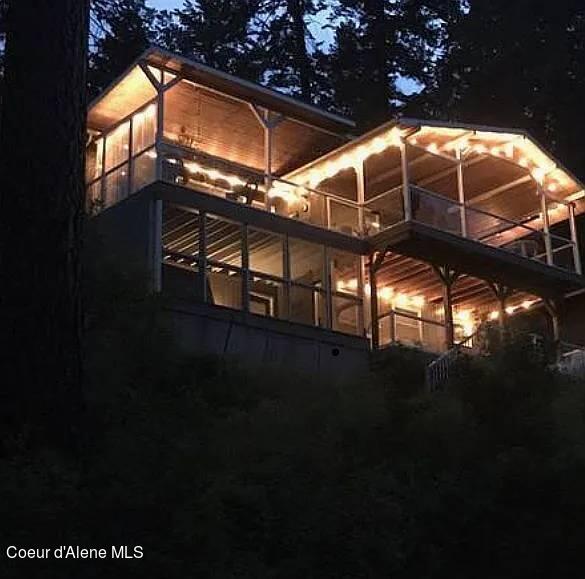 property exterior at night with a balcony