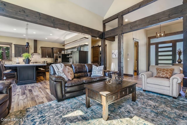 living room featuring vaulted ceiling with beams and hardwood / wood-style flooring