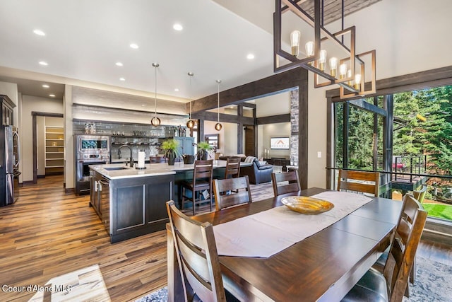 dining area featuring a chandelier, dark hardwood / wood-style floors, and sink