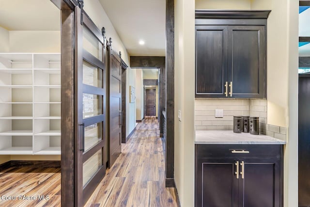 interior space with a barn door and light wood-type flooring