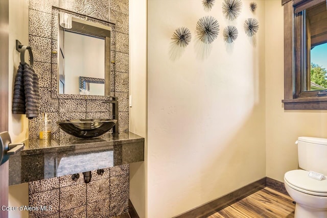 bathroom featuring sink, hardwood / wood-style floors, and toilet