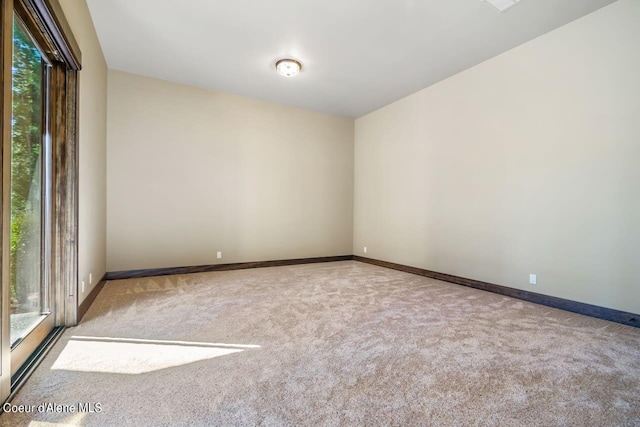 unfurnished room with light carpet and plenty of natural light