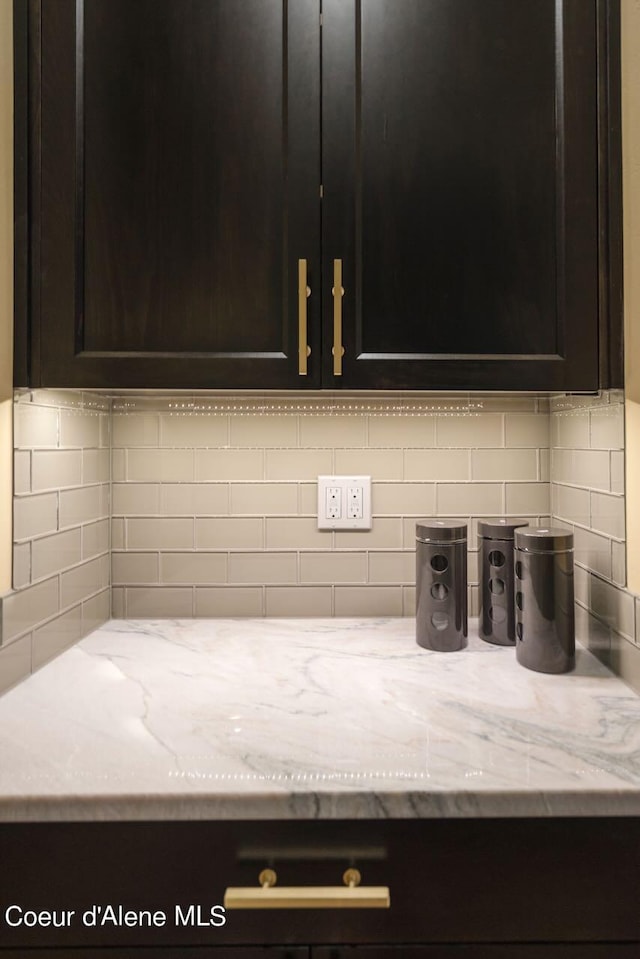 details with light stone countertops and tasteful backsplash