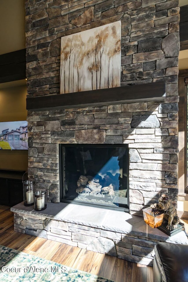 interior details with wood-type flooring and a fireplace