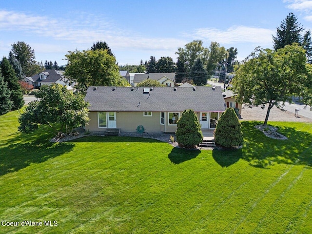 back of property featuring a lawn