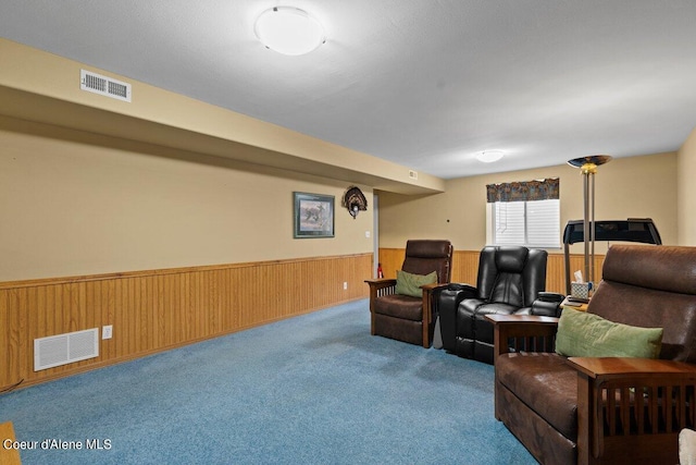 living room featuring wooden walls and carpet flooring