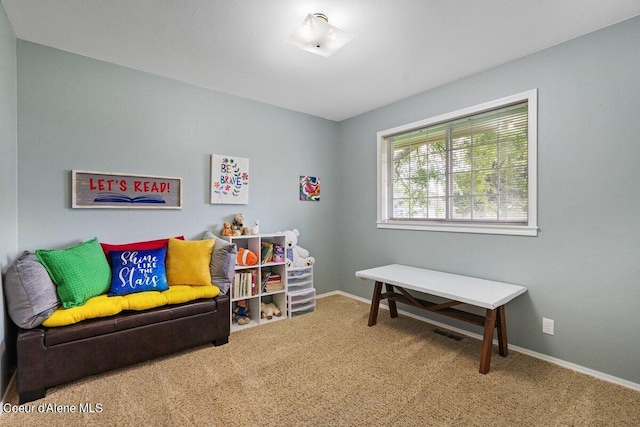 living area featuring carpet