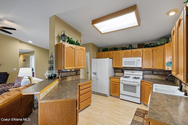 kitchen with white appliances, lofted ceiling, ceiling fan, light hardwood / wood-style flooring, and sink