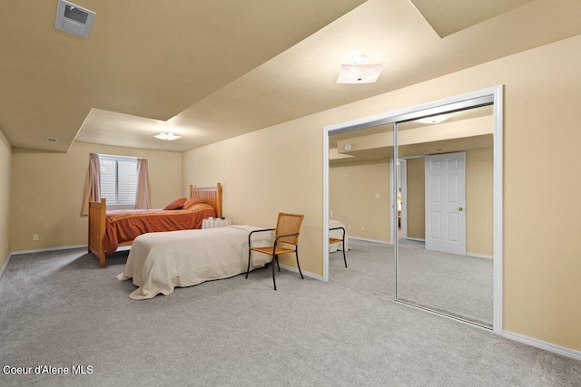 bedroom featuring light carpet and a closet