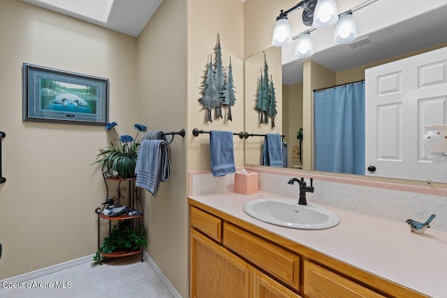 bathroom featuring a skylight and vanity