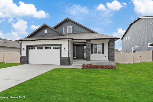 craftsman-style home featuring a garage and a front lawn