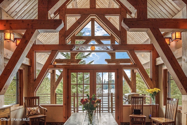 interior space with lofted ceiling with beams and a wealth of natural light