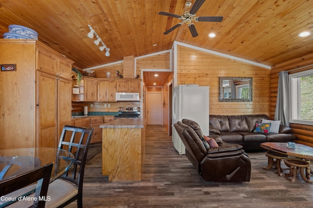 kitchen with white appliances, vaulted ceiling, and dark hardwood / wood-style floors