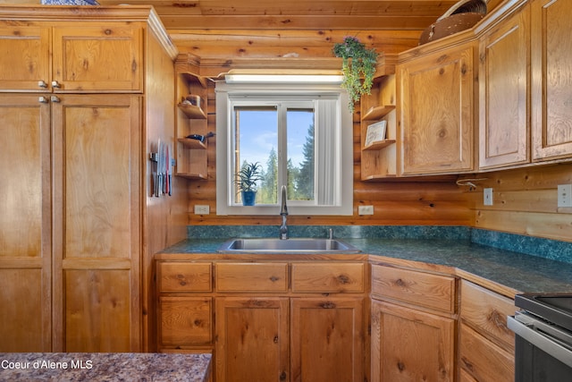 kitchen featuring wooden walls, stainless steel electric range oven, sink, and wooden ceiling