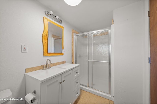 bathroom featuring tile patterned flooring, an enclosed shower, vanity, and toilet