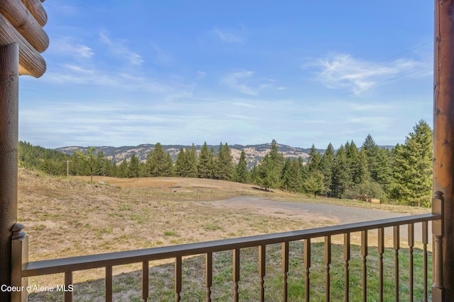 exterior space with a mountain view and a balcony