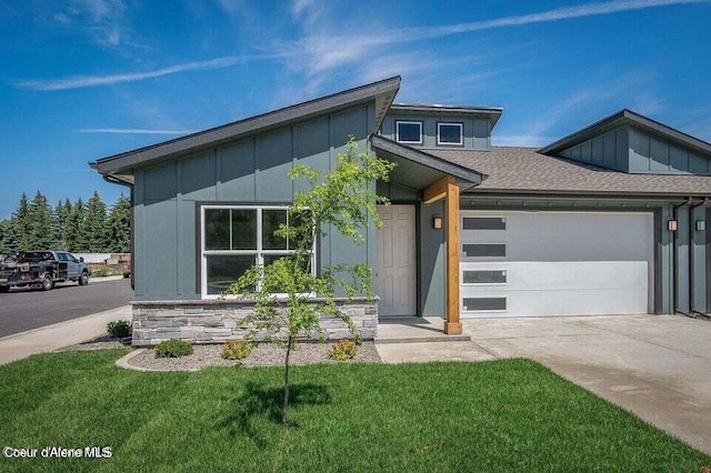 modern home featuring a front yard and a garage