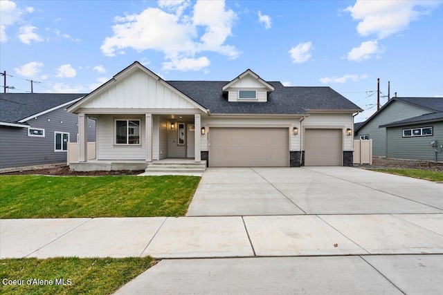 view of front facade with a front lawn, a porch, and a garage