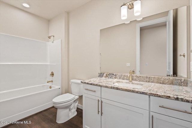 full bathroom with vanity,  shower combination, toilet, and wood-type flooring