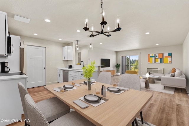 dining space with light wood finished floors, a chandelier, recessed lighting, and baseboards